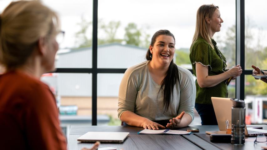 Smiling female talking at work