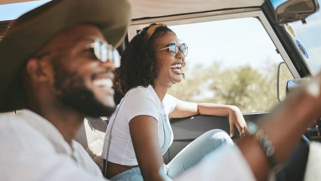 Happy young couple in a car in the countryside for a holiday, journey and freedom with happiness. 