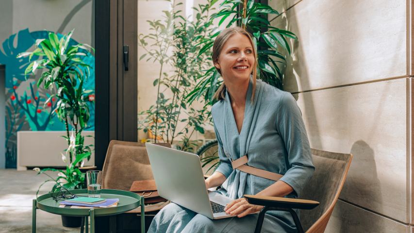 businesswoman with laptop on her knees