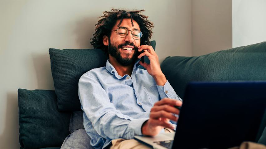 male working from home on the phone with laptop