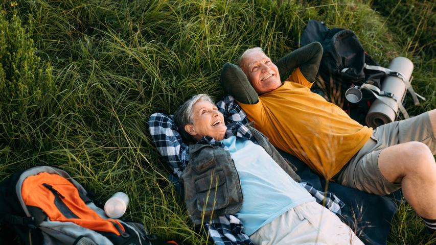 older couple lying on grass 