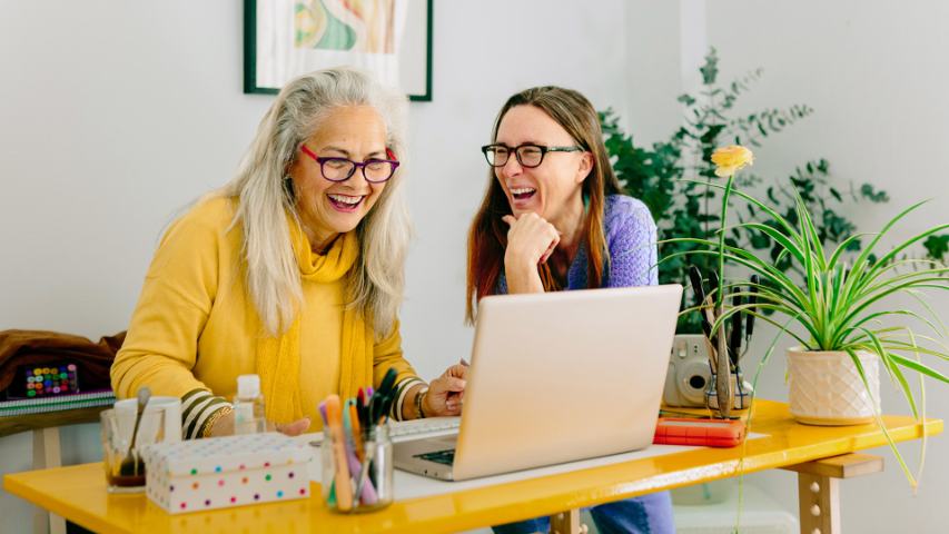 two female colleagues working at one desk