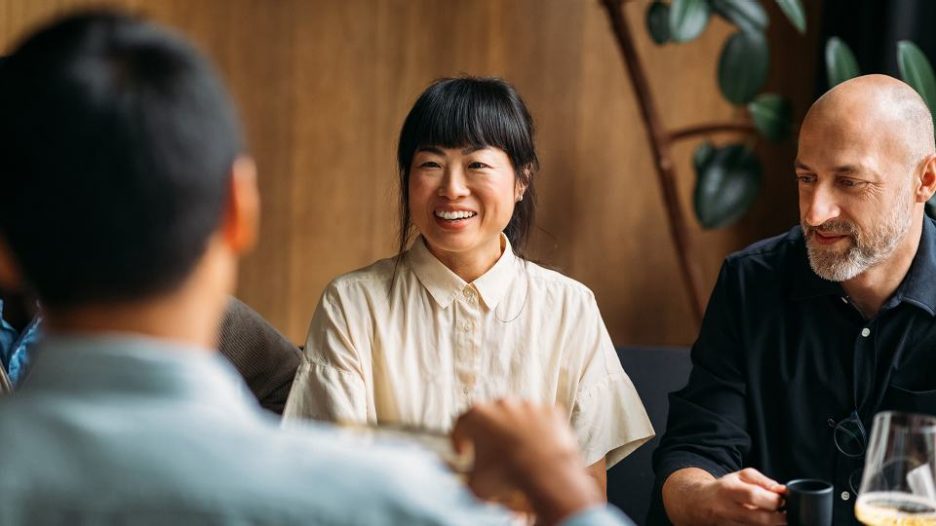 multiracial friends socializing in restaurant