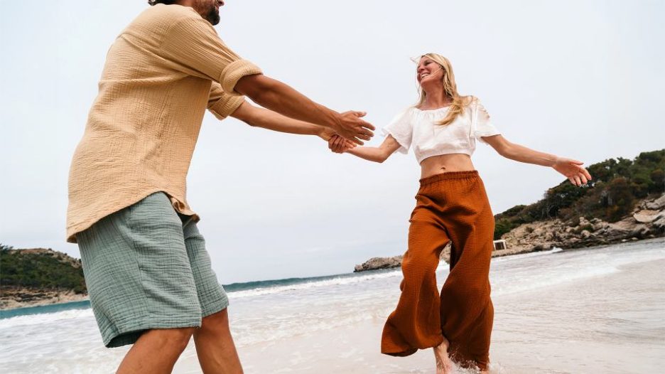 couple at the beach, expressing their love and happiness