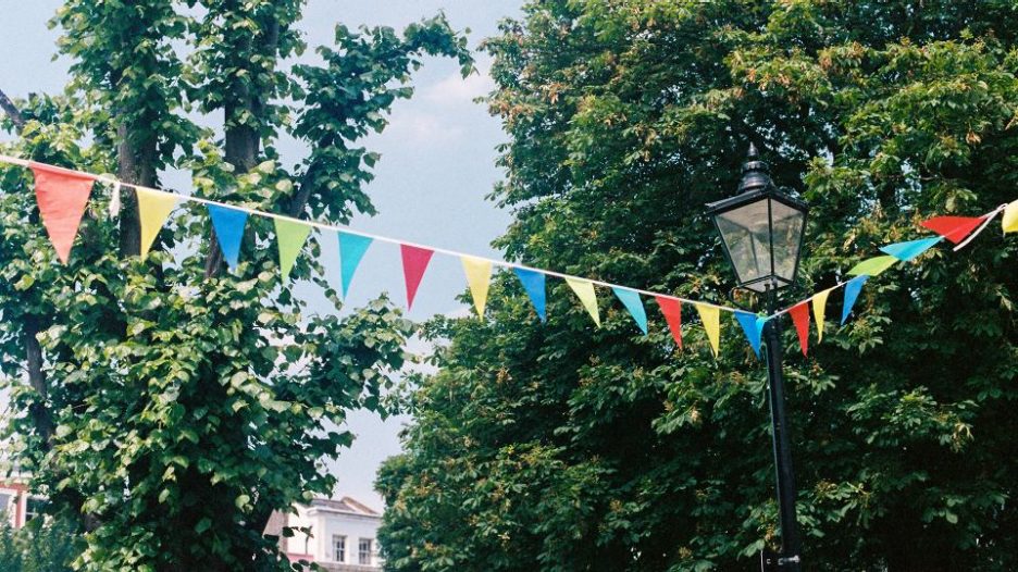 colourful bunting  on street with trees